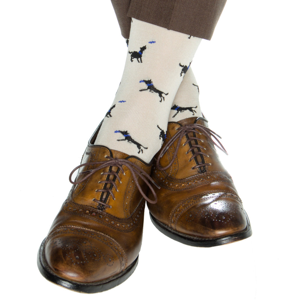 mid-calf tan sock with black dog catching frisbee