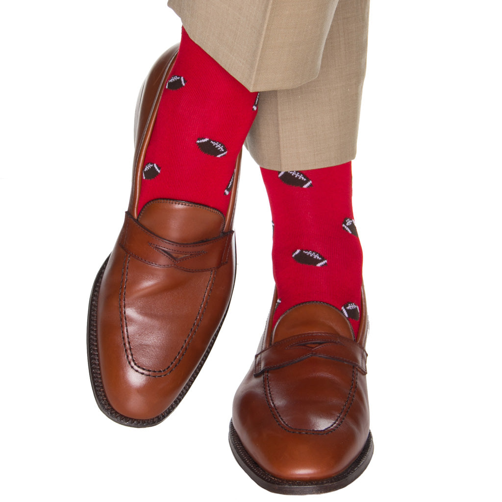 mid-calf red sock with footballs